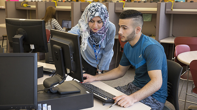 instructor helping student in lab