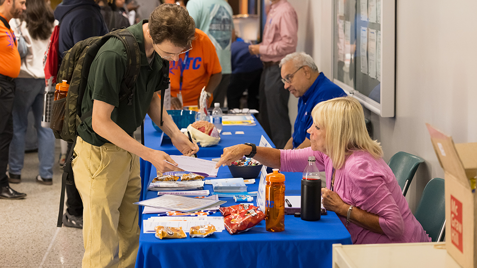 student getting help from an MATC staff member