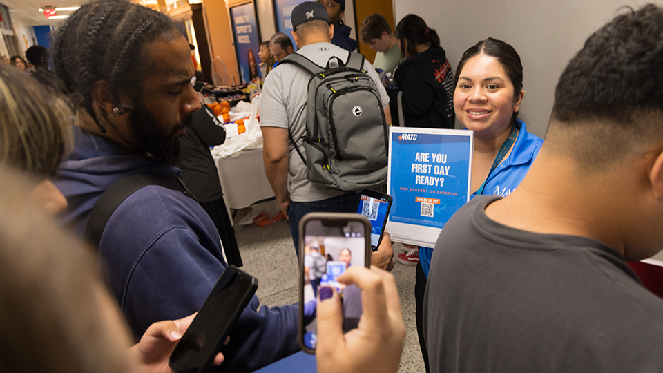 students scanning a QR code to get more information