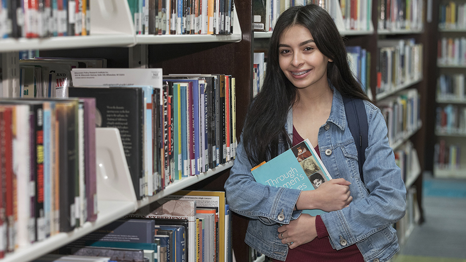 student in library