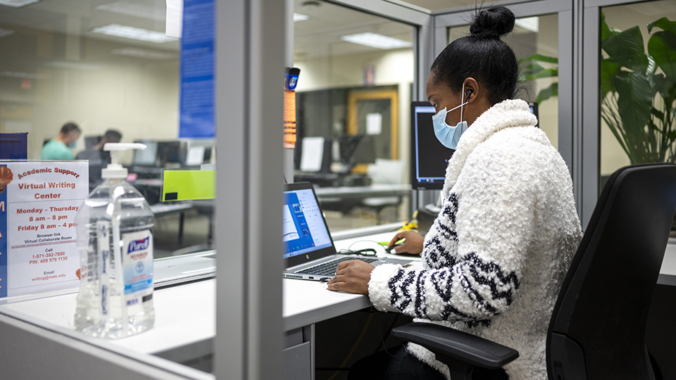 student with mask in academic support center