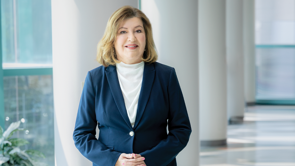 Dr. Martin stands in a campus's hallway