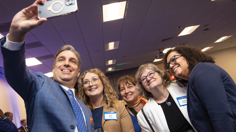 Dr. Cruz takes a photo with students