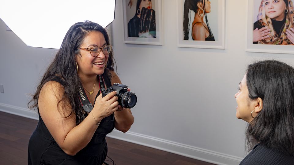 Nicole Acosta photographs a subject for the Hoops Project